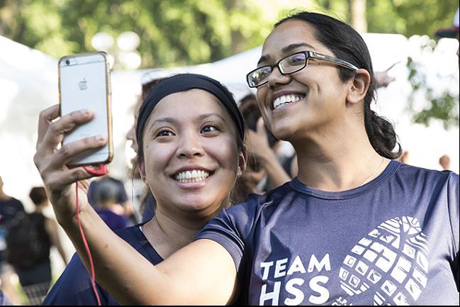 two participants of the JPM Corporate Challenge NYC smiling in the sun